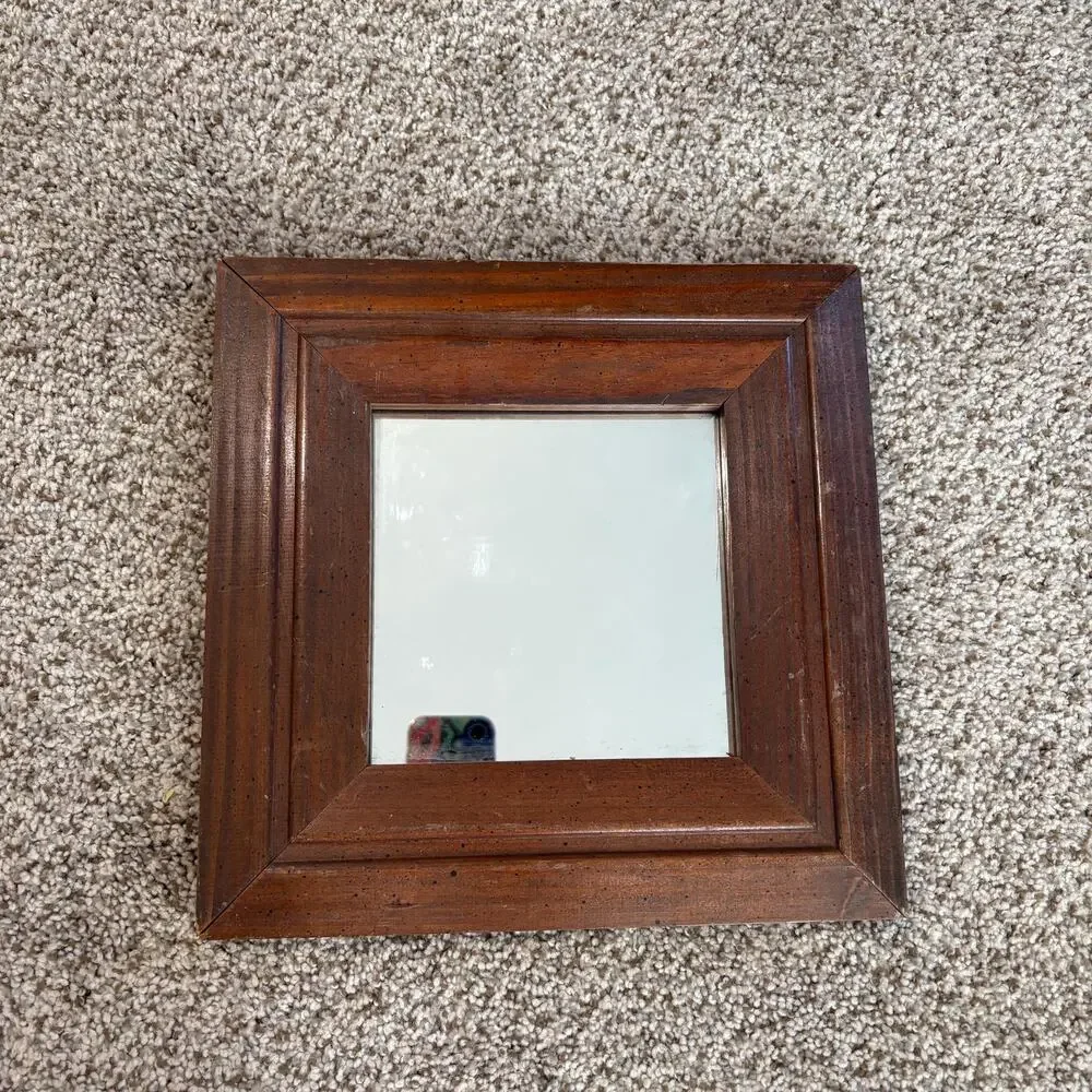 Vintage-style, square wall mirror features a thick, beveled solid wood frame